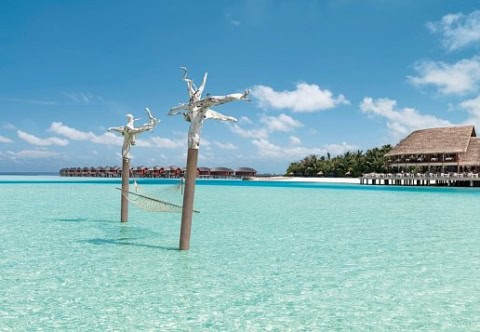 Lagune mit Hängematte im seichten Wasser vor dem Anantara Dhigu Maldives Resort.